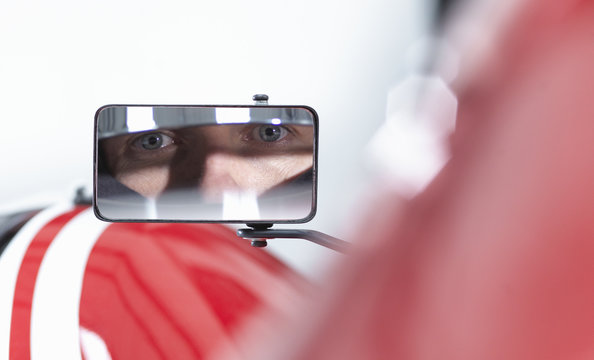 Portrait Of Racing Car Driver Reflected In Wing Mirror Of Supercar