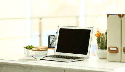 Fototapeta na wymiar Laptop on the table in the office