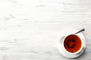 Cup of tea on white table, top view