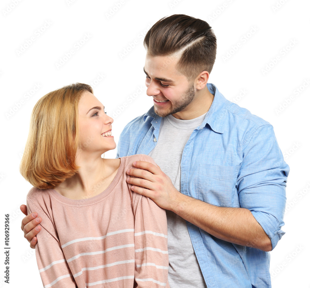 Wall mural young couple in love embracing, isolated on white