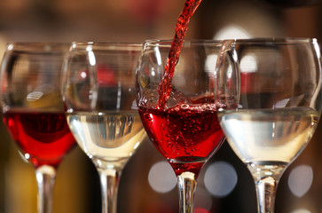 Red wine pouring into wine glass, closeup