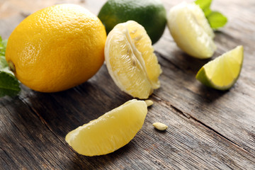 Lemon and lime slices with mint on wooden table