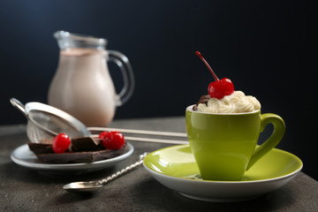 Chocolate cake in a mug with a cherry on top, close up