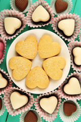 Valentine's Day concept. Composition of delicious chocolate candies and tasty cookies, close up