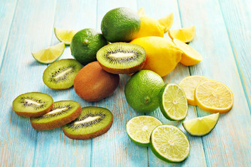 Juicy composition of tropical fruits on wooden background, close up