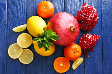 Juicy composition of tropical fruits on blue wooden background