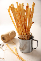 Bread sticks grissini with sesame seeds in a metal cup