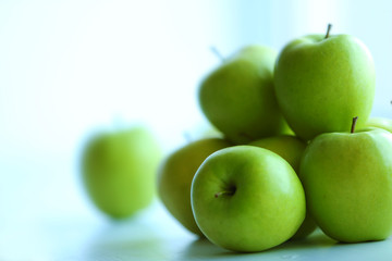 Ripe green apples on a windowsill