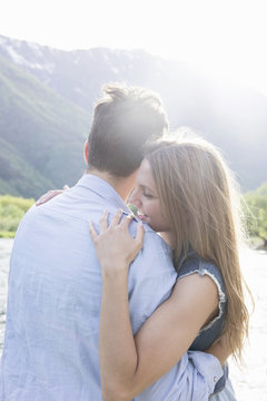 Romantic young couple on riverbank