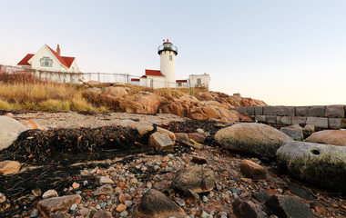 Fototapeta na wymiar Eastern Point Lighthouse at Gloucester at Sunset, Massachusetts, USA. One of the five iconic lighthouses have been built along the Cape Ann coastline to protect seafarers from rocky shores and shoals.