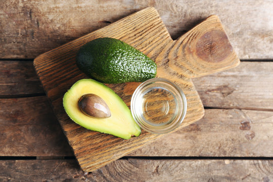 Fresh avocados  on wooden board, top view