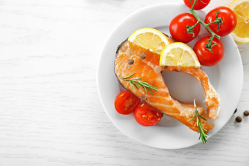 Fish with vegetables on plate