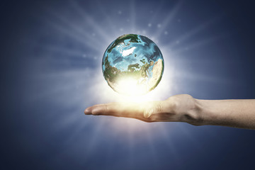 Human hand holding globe