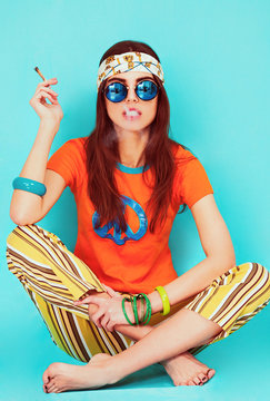 Beautiful hippy girl portrait sitting and smoking weed