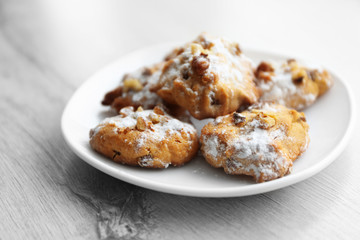 Plate of nut biscuits on wooden background, closeup