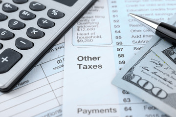 1040 Income Tax Form and dollar bills, close up