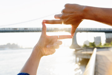 Woman's fingers framing Manhattan Bridge, Brooklyn, USA