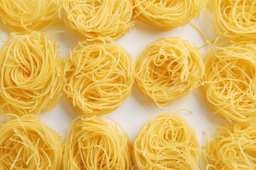 Bird's nests pasta background, top view