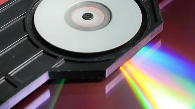 Inserting medium and reading CD disk in player mechanism 4K 2160p UltraHD footage - DVD disc in players mechanism rotating fast 4K 3840X2160 UHD video 