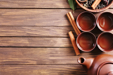 Green tea with ceramic utensils on wooden background