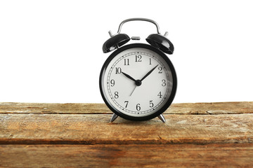 Alarm clock on wooden table.