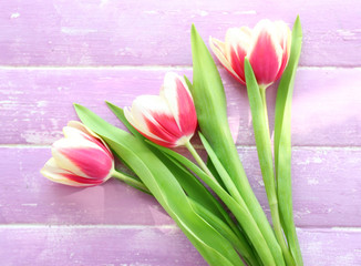 Bouquet of variegated tulips on wooden background
