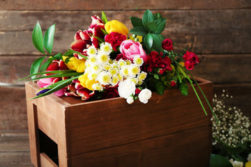 Bouquet of fresh flowers on a wooden box