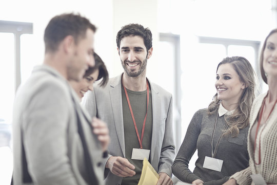 Businesswomen and businessmen in conference centre atrium