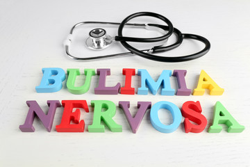 Bulimia nervosa  colorful words and stethoscope on white background.