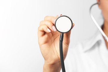 Young female doctor with stethoscope, close up