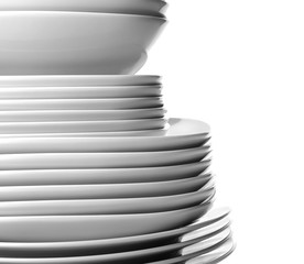 Stack of different ceramic plates, isolated on white