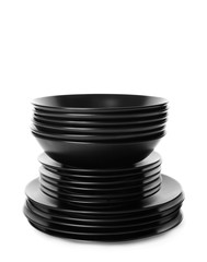 Stack of different black ceramic plates, isolated on white