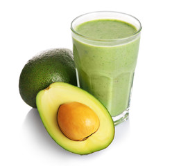 Glass of fresh avocado cocktail and avocado fruit isolated on white