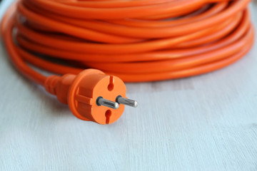 Orange rolled extension on wooden surface closeup