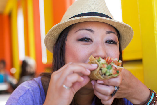 Woman eating Lebanese bread wrap