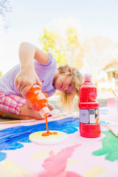 Girl painting with tempera on paper