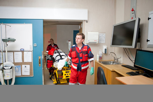 Paramedics moving patient to emergency room in hospital