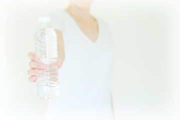 young woman show bottle of water . isolated