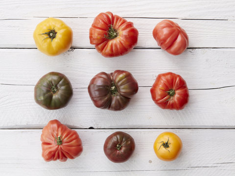 Arrangement of nine heirloom tomatoes