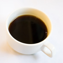 The close up of cup of black coffee in the ceramic coffee cup.