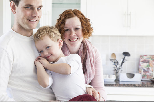 Portrait of mid adult couple and four year old son