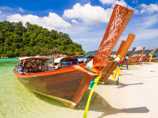 Long tail wooden boat and tropical beach
