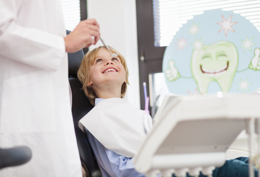 Boy in dentists chair having check up