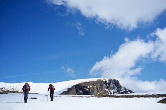 Two men hiking in snow, Bucegi Mountains, Transylvania, Romania