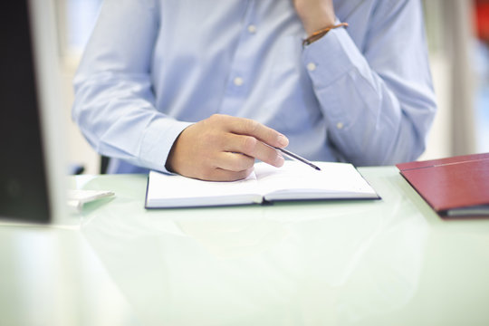 Mature businessman organizing his diary