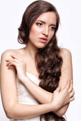 Fototapeta premium Portrait of beautiful young brunette woman bride in white Weddi