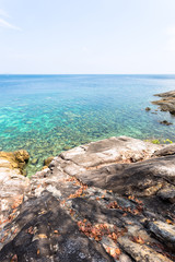 Fototapeta na wymiar Beach rock clear water and coral under clear water. Paradise Island top view. LIPE Thailand