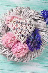 Pink and blue  hyacinths flowers on wreath and decorative heart