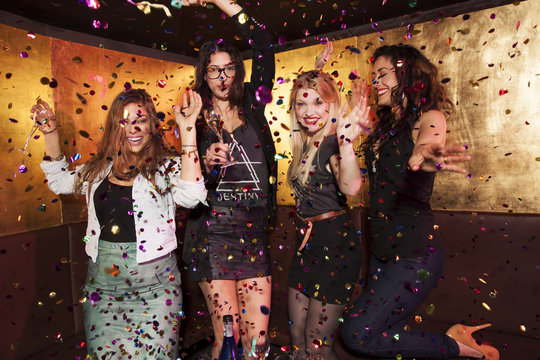 Four female friends partying in nightclub