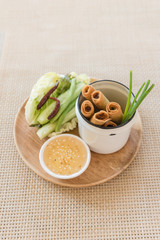 plate of spring rolls with sweet chili dip sauce